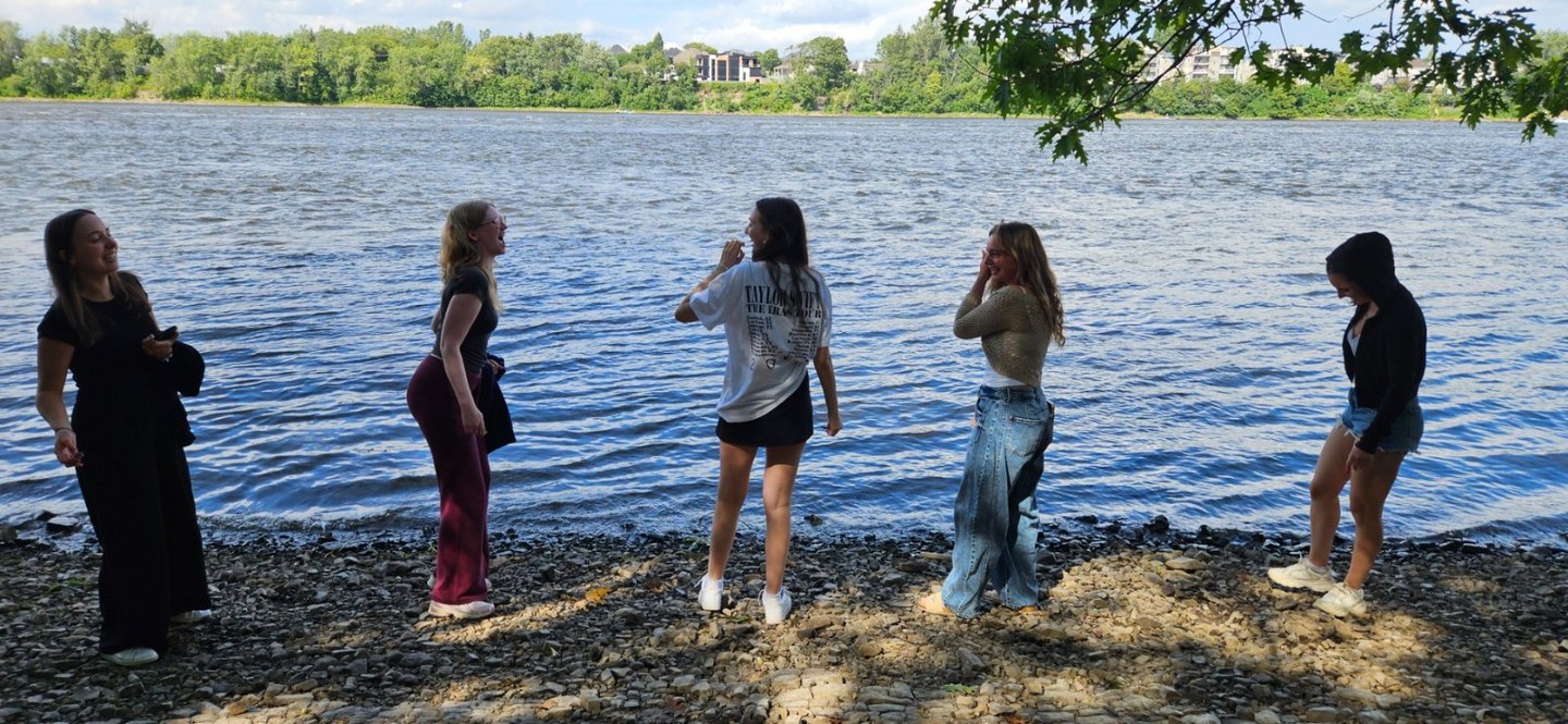 A group of women together by the water on a summer afternoon