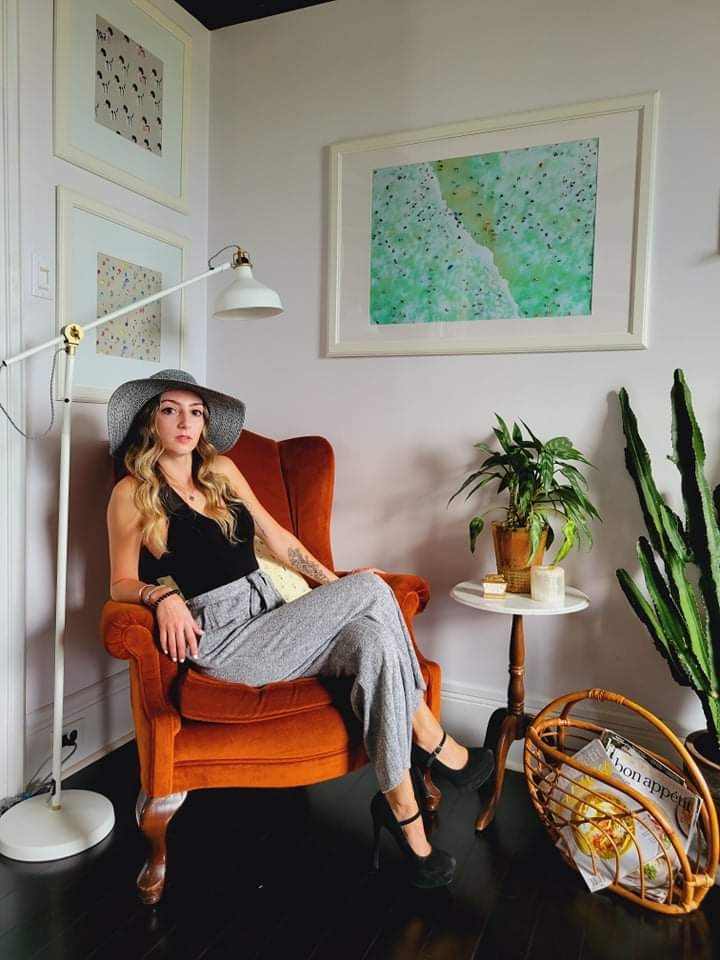 Felicia at home, in a velvet armchair