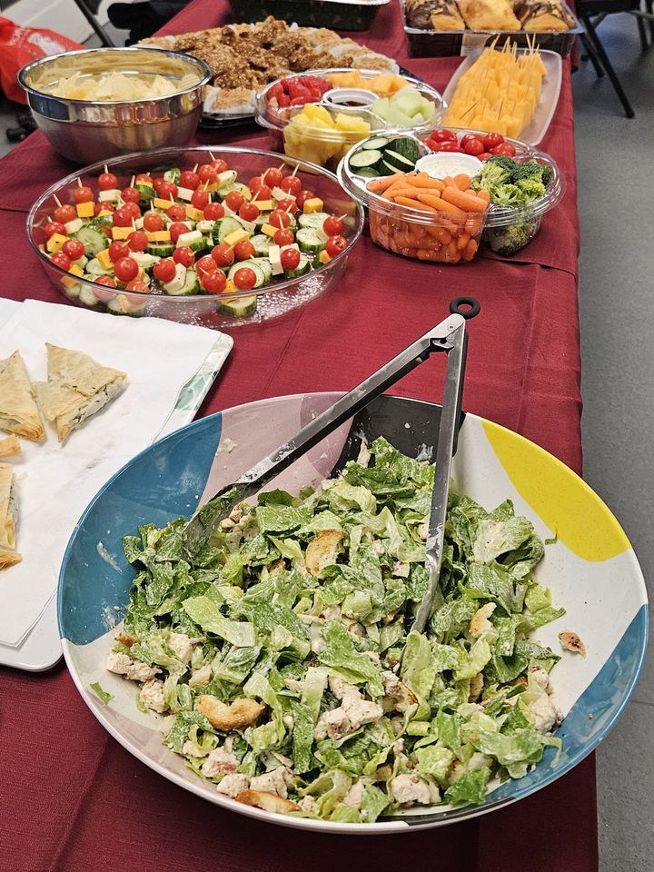 A long table of salads and snacks for the evening